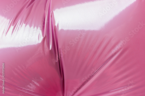 Detail of the folds of a helium pink balloon from foil