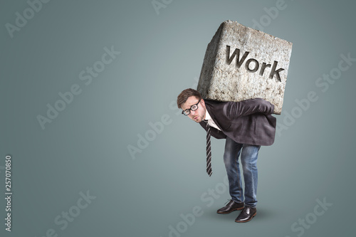 Concept of an entrepreneur bending under a heavy workload
