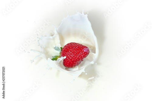 splash of white milk with red strawberries