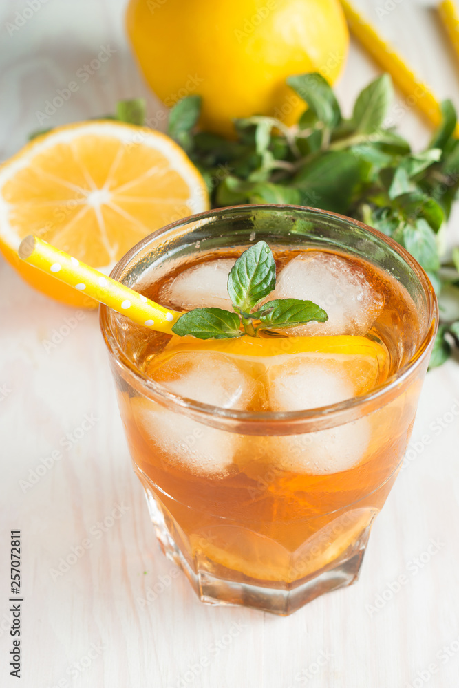 Refreshing citrus lemonade, summer drink. Ice tea with fresh lemon and mint on wooden background. Refreshment beverage concept. Refreshing citrus lemonade, summer drink. Ice tea with fresh lemon and mint on wooden background. Refreshment beverage concept.
