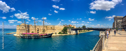 Overview of the Italian training ship Palinuro docked at the Aragonese Castle with a view of the navigable canal and the swing bridge of the city of Taranto, Puglia, Italy  photo