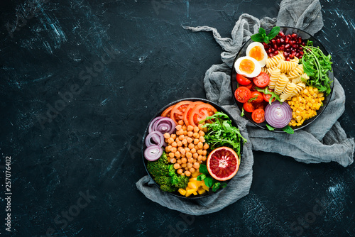 Healthy food. Assortment of the Buddha Bowl on a black background. Top view. Free space for your text.