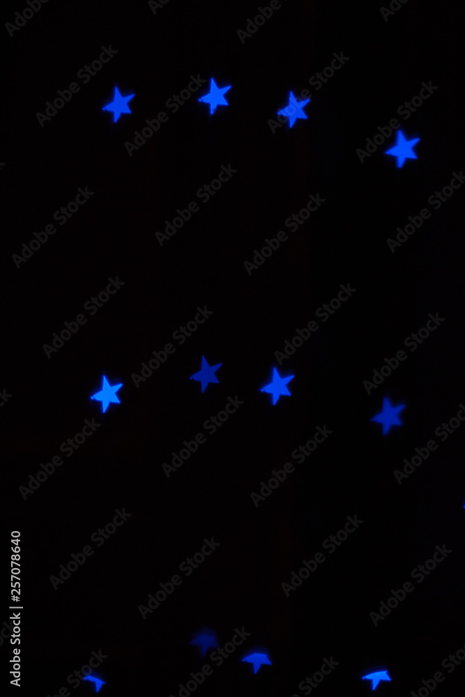 neon light of Christmas garlands in the form of stars on a dark background neon light of Christmas garlands in the form of stars on a dark background