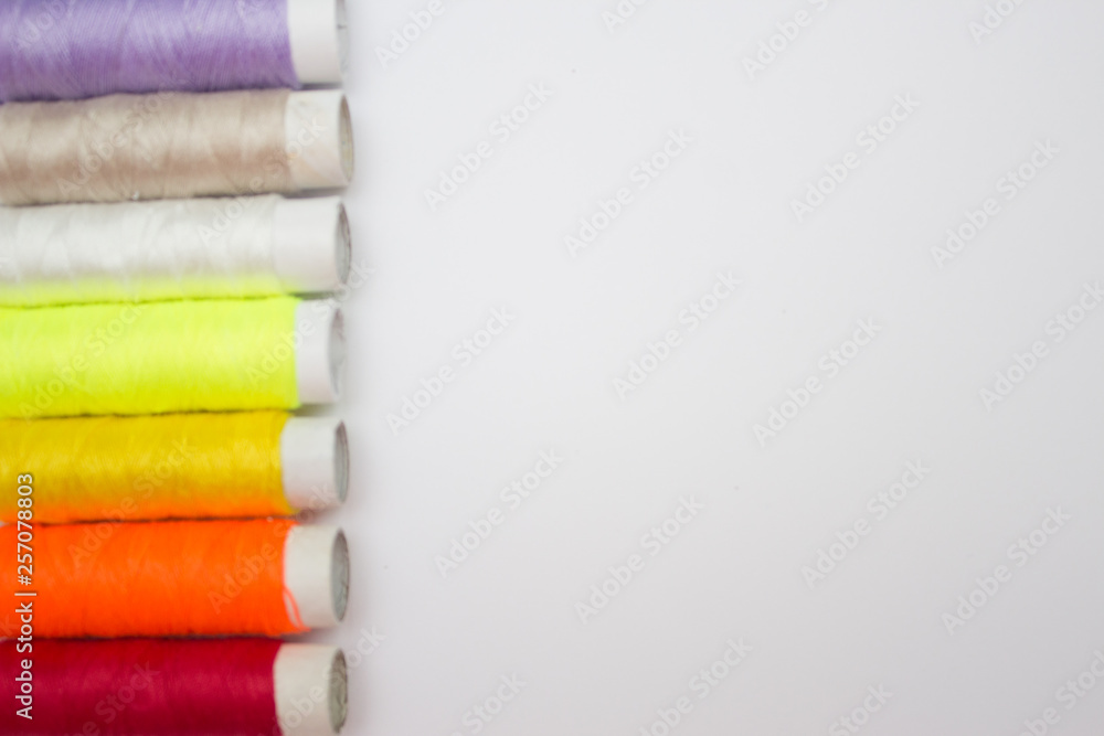 Colored sewing thread, background, Copy space Colored sewing thread, background, Copy space