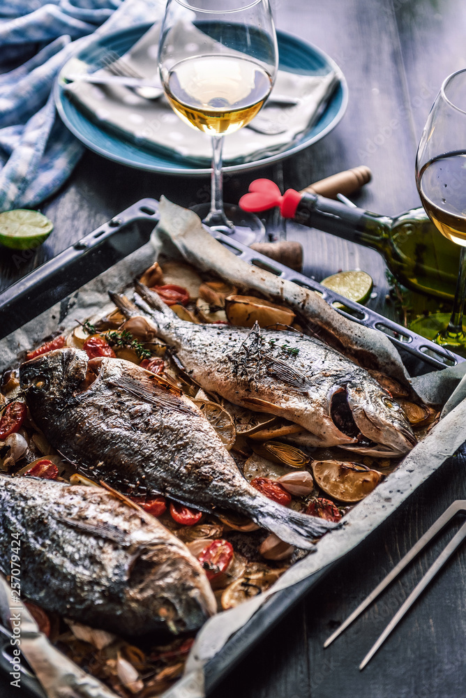 mother cooks dinner for the whole family, bakes dorado fish