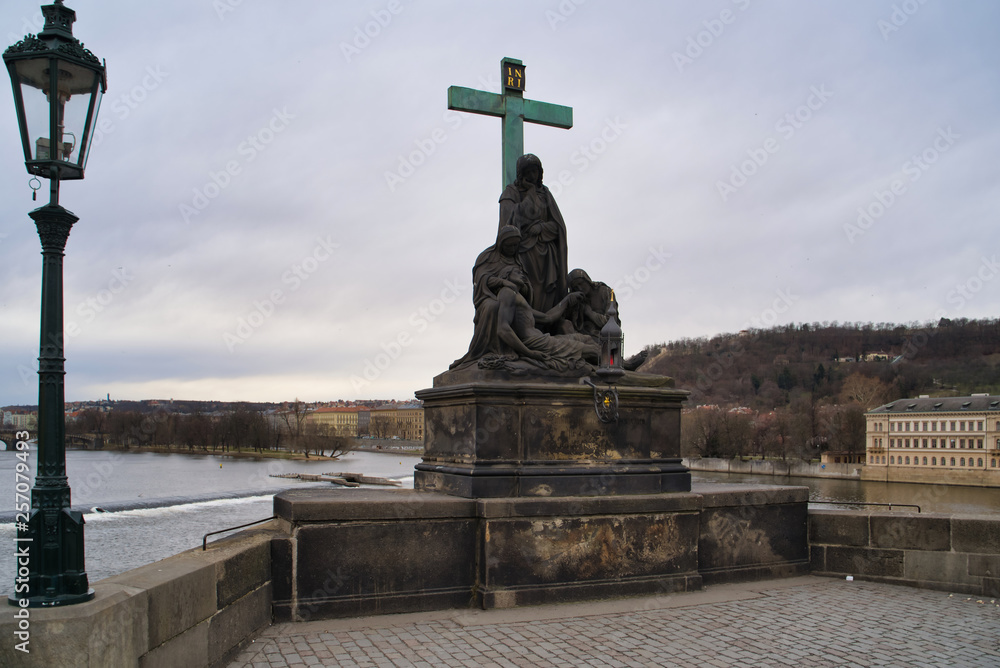 Prague, Czech Republic - March 04, 2019: Sculpture on the Charles Bridge - Lamentation of Christ, an episode of the Passion of Christ
