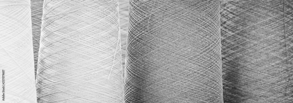Black and white reels of threads. web banner background - obrazy, fototapety, plakaty 