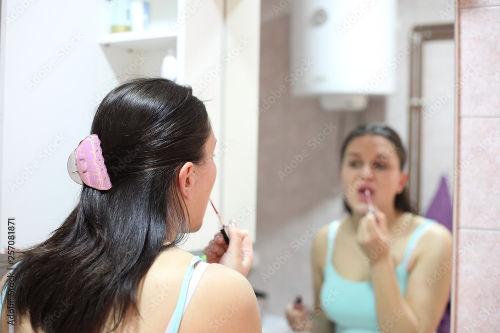 A portrait of beautiful European women making makeup and preparing for a nightclub A portrait of beautiful European women making makeup and preparing for a nightclub