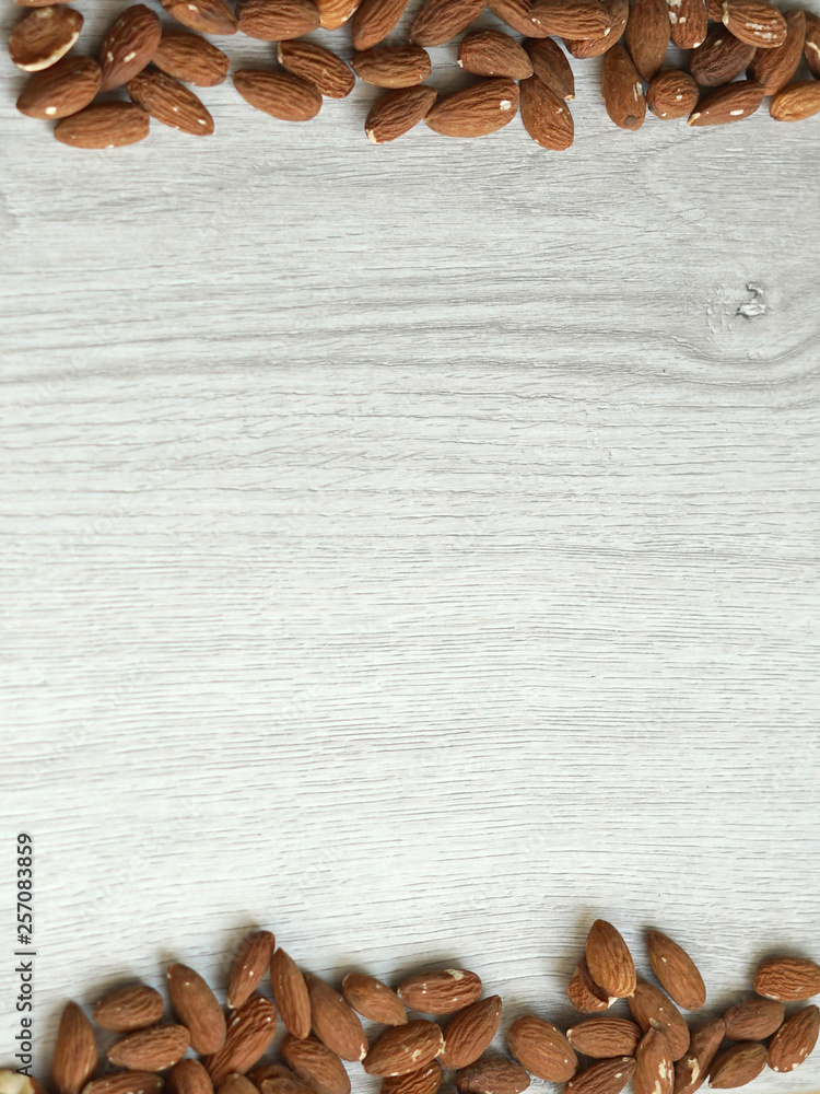 Healthy food for background image close up almond nuts. Texture on white grey table top view Healthy food for background image close up almond nuts. Texture on white grey table top view