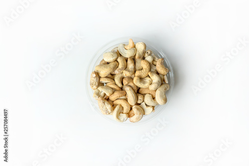 Healthy food  for background image close up cashew nuts.  Nuts texture on white grey table top view on the cup plate
