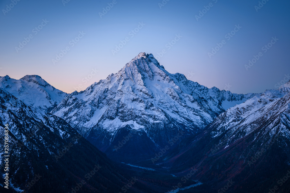 High snowy mountain in the evening after sunset