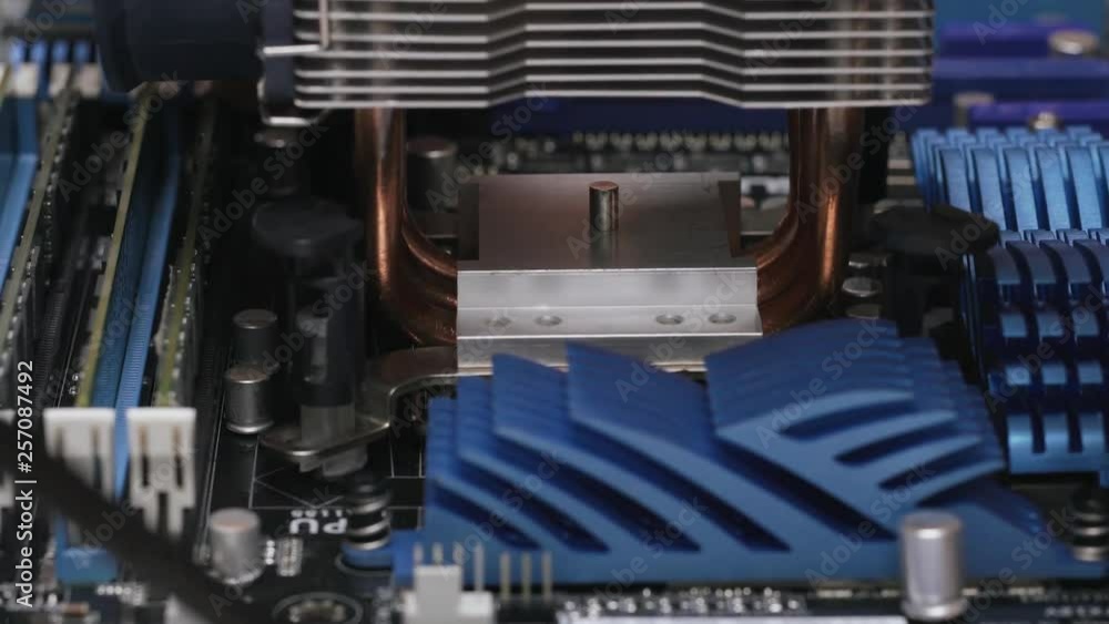 Computer Run On A Car Radiator Build a computer, close-up view, 4K. A male service worker installs a ...
