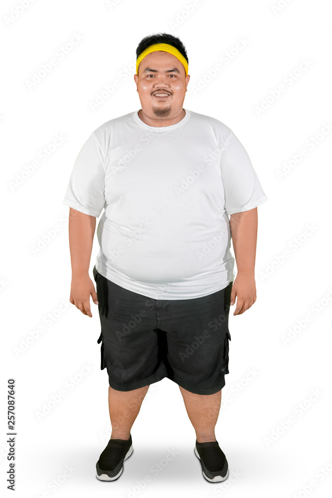 Happy fat man stands with sportswear on studio Happy fat man stands with sportswear on studio