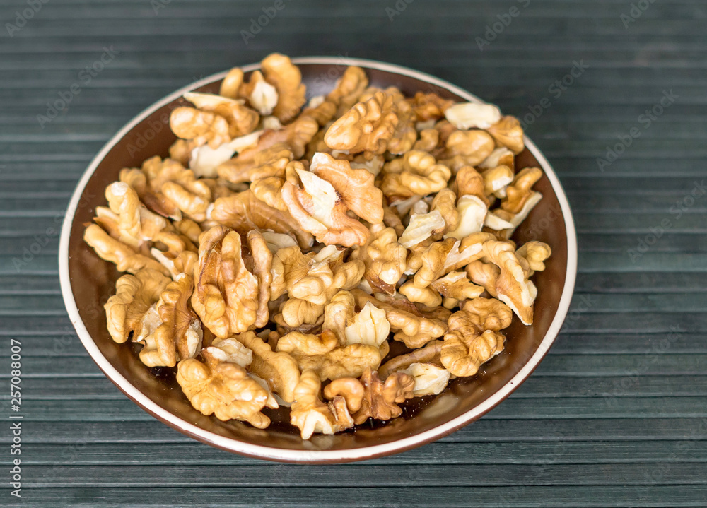 Healthy food for background image close up walnuts. Nuts texture on top view on the cup plate Healthy food for background image close up walnuts. Nuts texture on top view on the cup plate