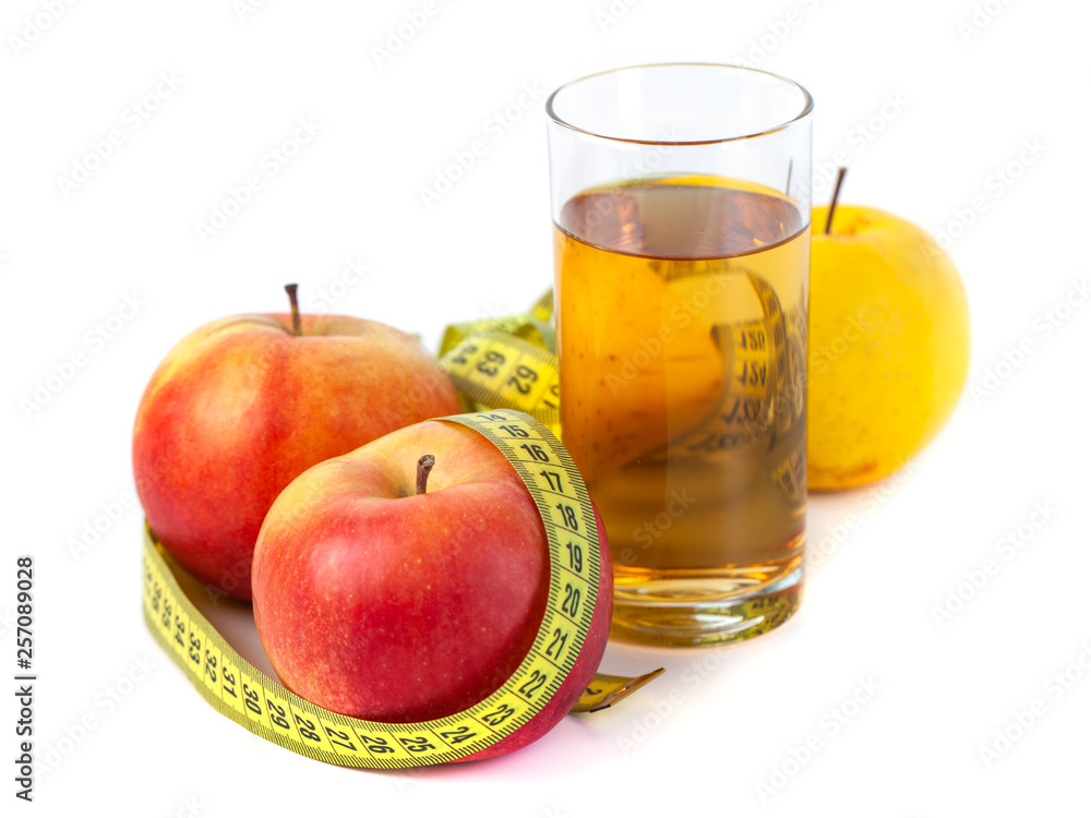 apple and apple juice with tape measure on white background apple and apple juice with tape measure on white background