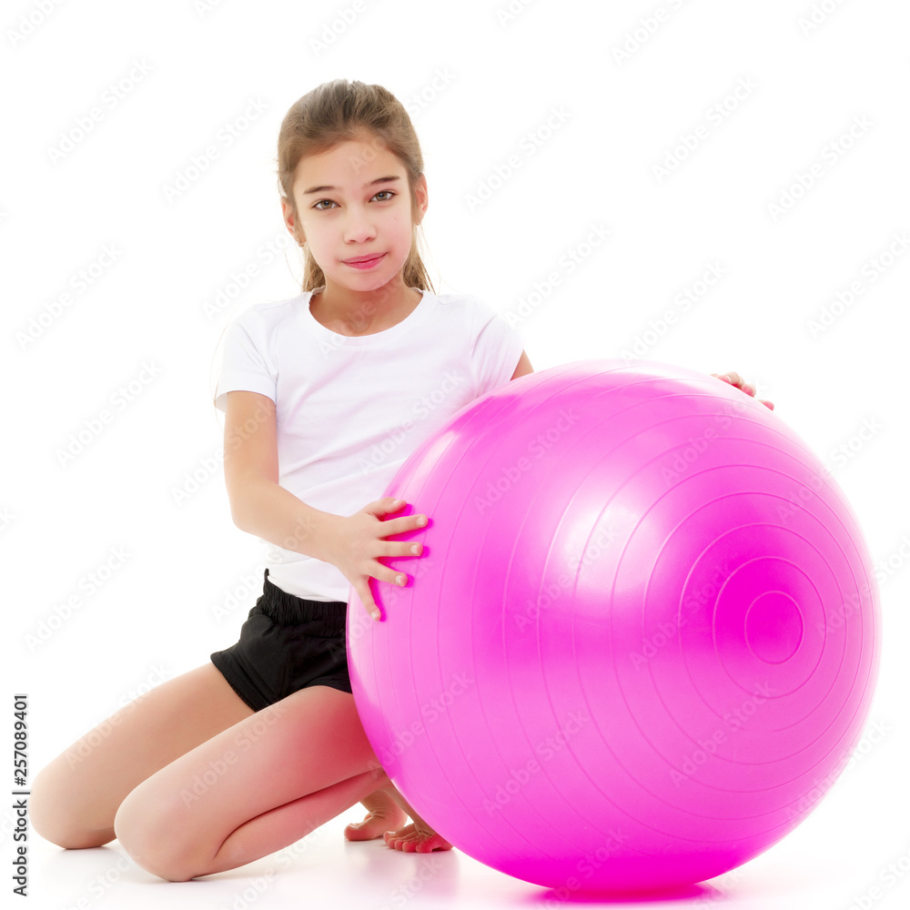little girl doing exercises on a big ball for fitness. little girl doing exercises on a big ball for fitness.