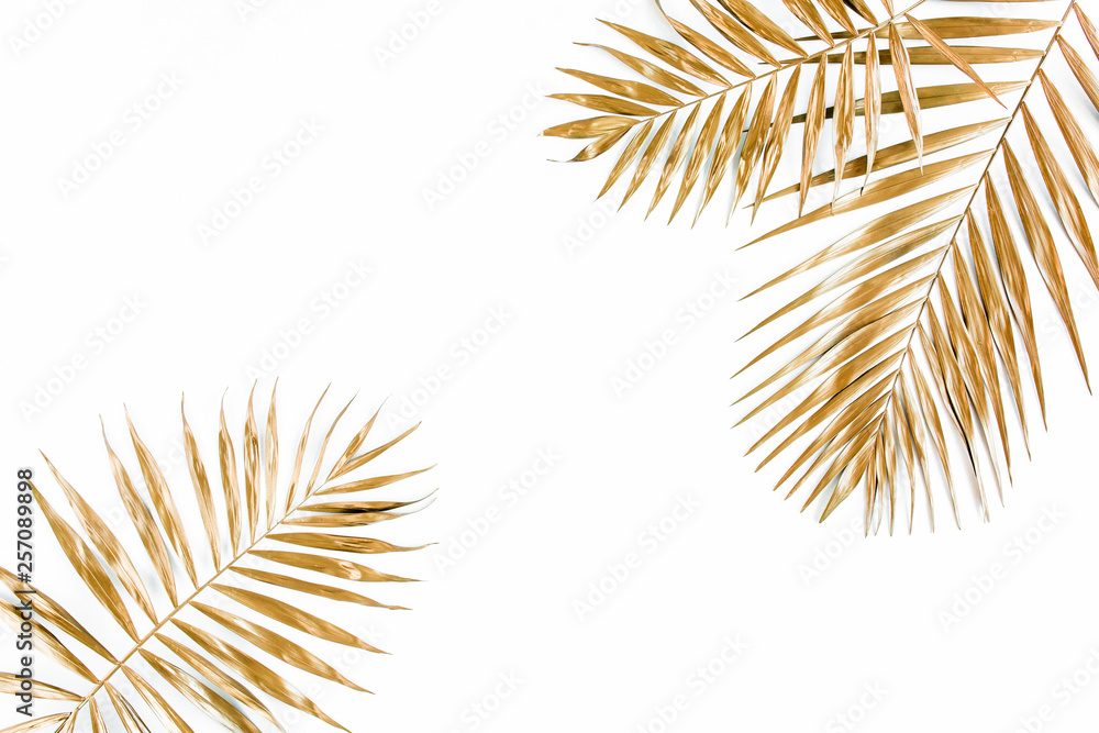 Fototapeta premium Gold tropical palm leaves on white background. Flat lay, top view minimal concept.