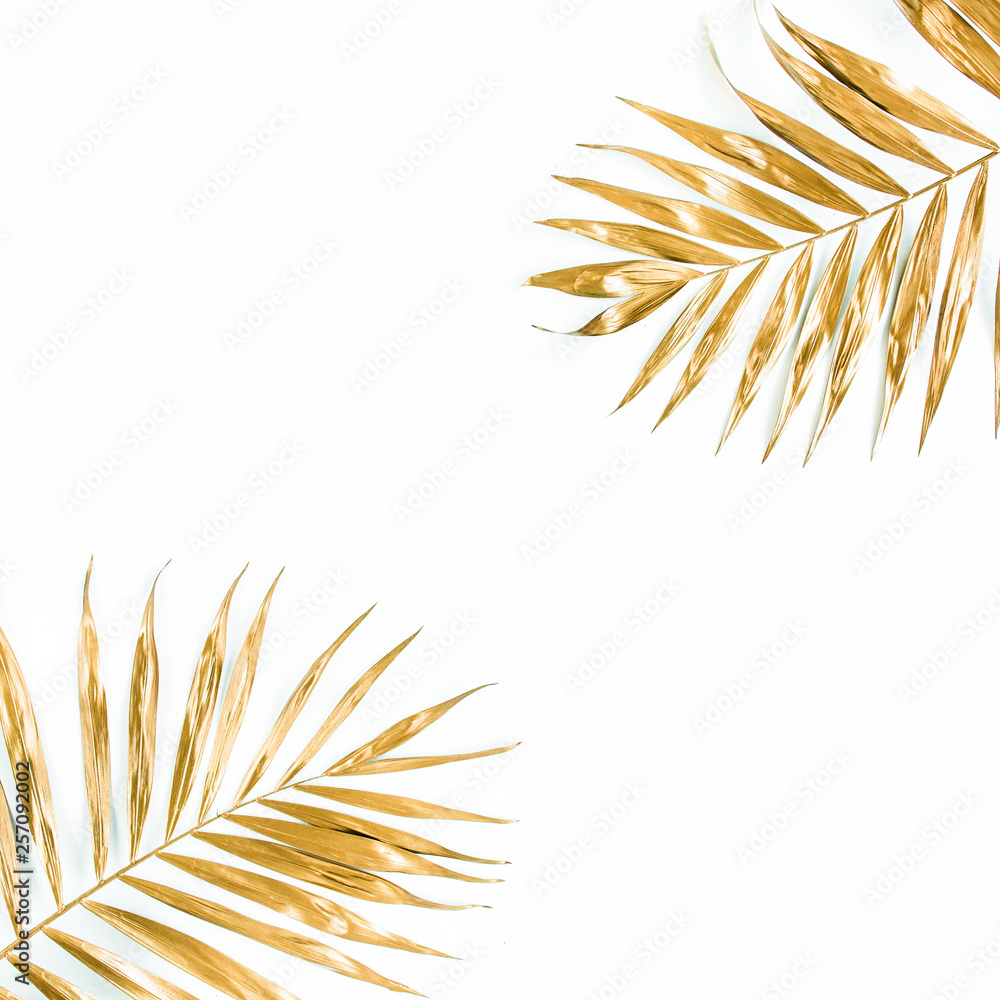 Gold tropical palm leaves on white background. Flat lay, top view minimal concept. Gold tropical palm leaves on white background. Flat lay, top view minimal concept.