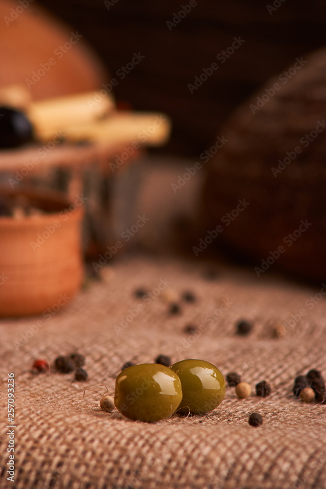 olive is on the table in background of bread, baguette and cheese. Selective focus olive is on the table in background of bread, baguette and cheese. Selective focus