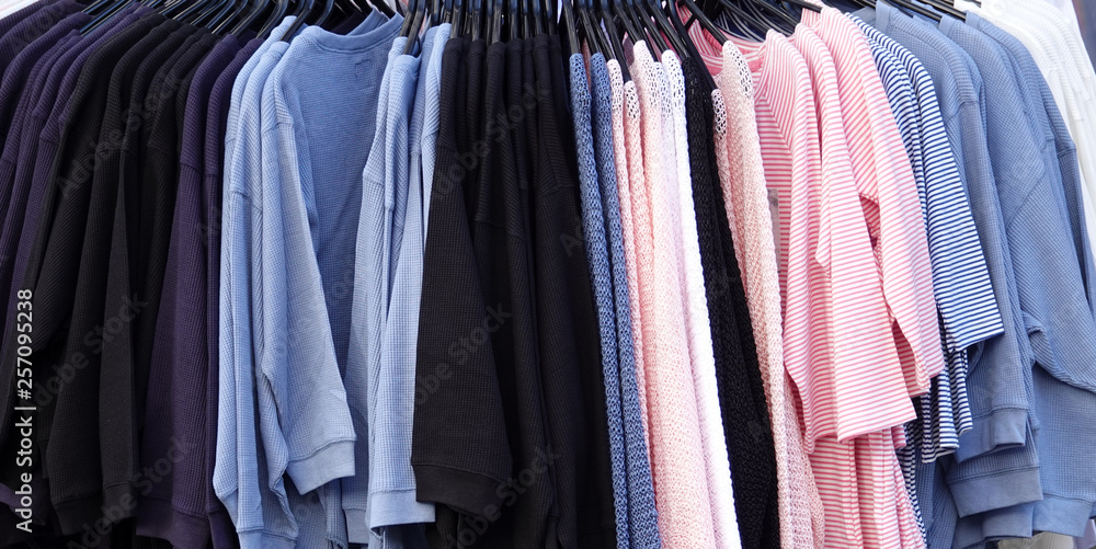 Clothes hanging in shopping center store Clothes hanging in shopping center store