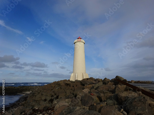 Lighthouse in Akranes, West Iceland on a rocky beach