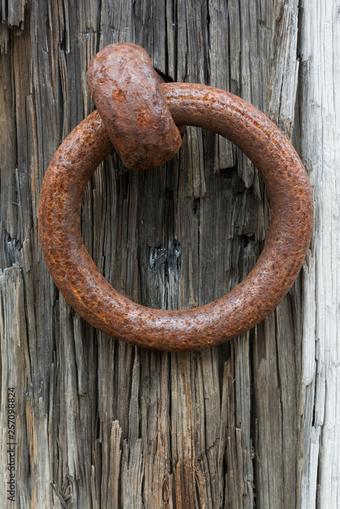 Corroding Metal Ring Attached to Old Railway Sleeper Corroding Metal Ring Attached to Old Railway Sleeper