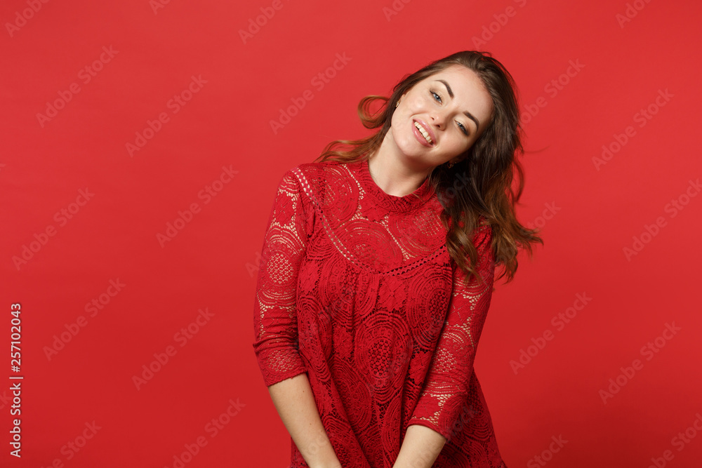 Portrait of attractive sexy young woman in lace dress standing and looking camera isolated on bright red wall background in studio. People sincere emotions, lifestyle concept. Mock up copy space. Portrait of attractive sexy young woman in lace dress standing and looking camera isolated on bright red wall background in studio. People sincere emotions, lifestyle concept. Mock up copy space.