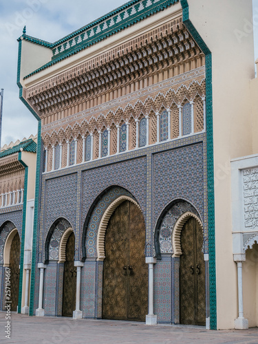 huge golden gate of the  Royal Palace of Fez on a beautiful afternoon with blue Sky in Morocco, Africa photo