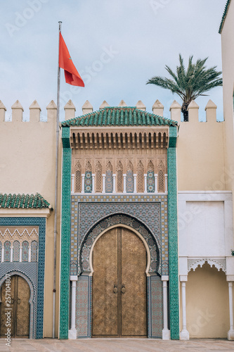 Royal Palace of Fez with the red flag of Morocco on a beautiful afternoon with blue Sky in Morocco, Africa