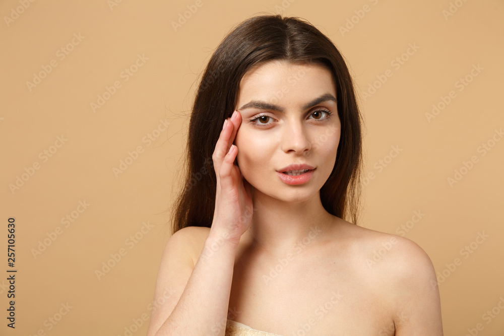 Close up brunette half naked woman 20s with perfect skin, nude make up isolated on beige pastel wall background, studio portrait. Skin care healthcare cosmetic procedures concept. Mock up copy space. Close up brunette half naked woman 20s with perfect skin, nude make up isolated on beige pastel wall background, studio portrait. Skin care healthcare cosmetic procedures concept. Mock up copy space.