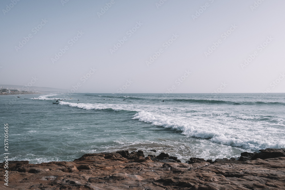 Surfers surfing the Waves of Taghazout at the West Coast of Morocco, Africa