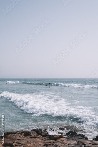 Surfers surfing the Waves of Taghazout at the West Coast of Morocco, Africa photo