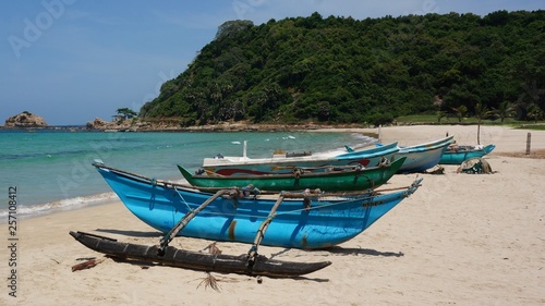 lonley beach with traditional old used fishing boats © Fizzl