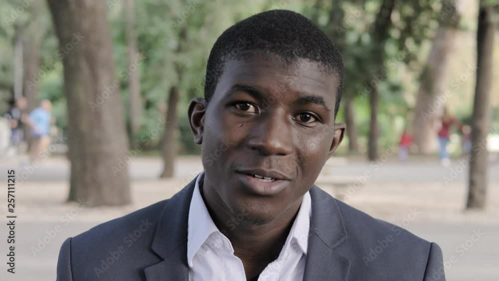 Happy confident young black business man talking with camera in the park Happy confident young black business man talking with camera in the park