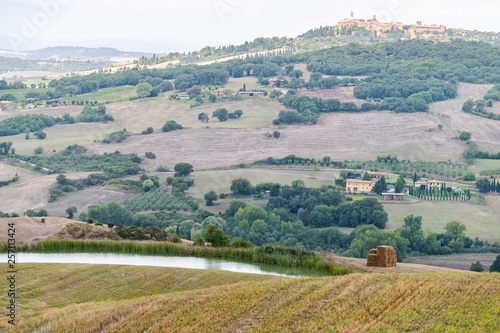 Pienza skyline and Italy Val D'Orcia countryside in Tuscany with lake and hilltop small town village high angle cityscape