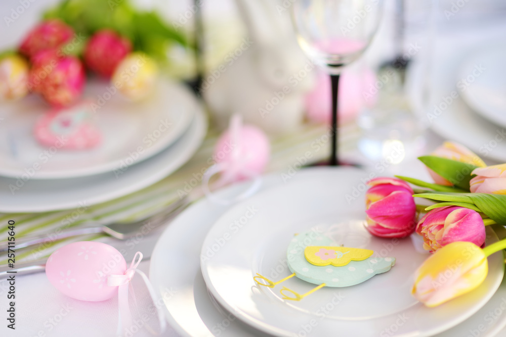 Beautiful table setting with crockery and flowers for Easter celebration.