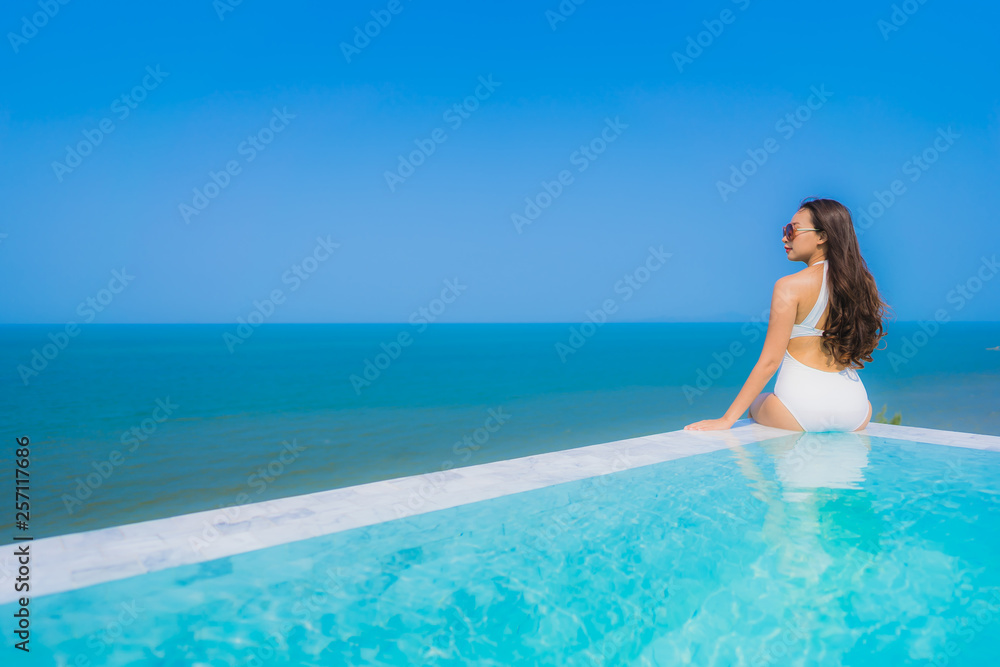 Portrait beautiful young asian woman happy smile relax in swimming pool for travel vacation Portrait beautiful young asian woman happy smile relax in swimming pool for travel vacation