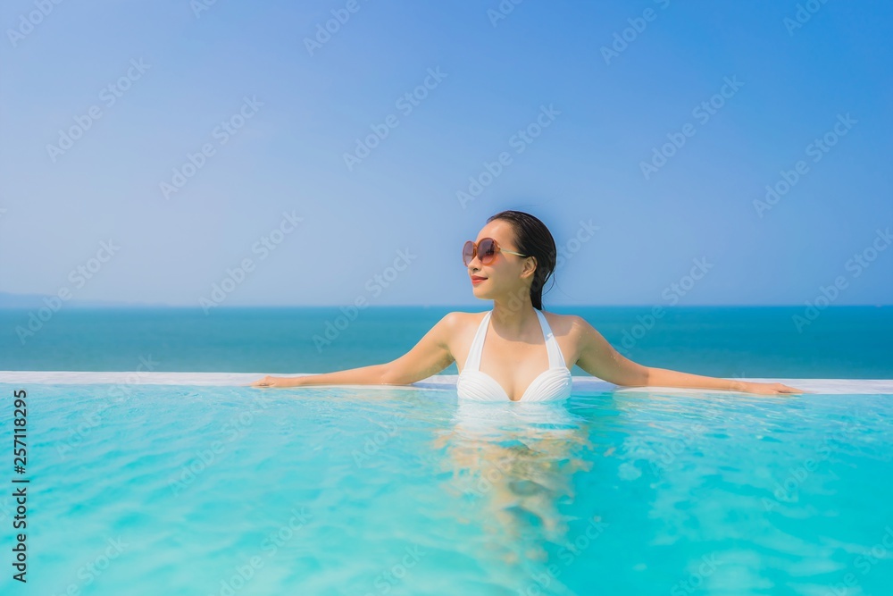 Portrait beautiful young asian woman happy smile relax in swimming pool for travel vacation Portrait beautiful young asian woman happy smile relax in swimming pool for travel vacation