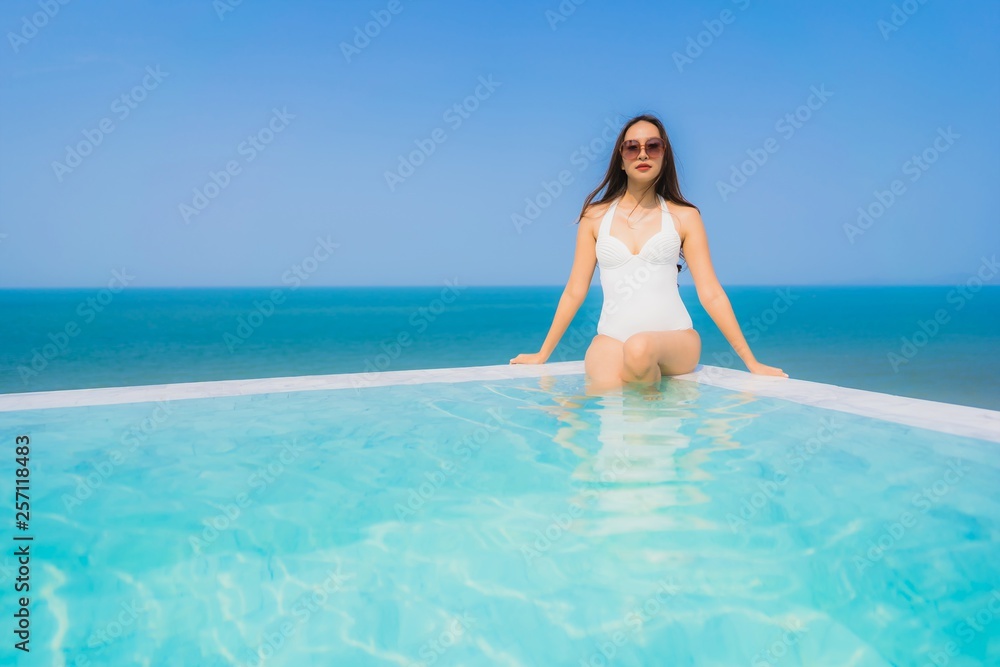 Portrait beautiful young asian woman happy smile relax in swimming pool for travel vacation Portrait beautiful young asian woman happy smile relax in swimming pool for travel vacation