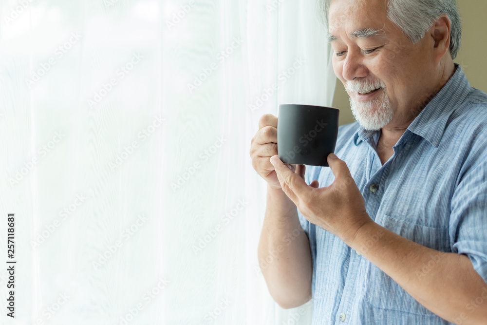 Senior male feel happy drinking coffee in the morning, enjoying time in his home indoor background - lifestyle senior happiness concept Senior male feel happy drinking coffee in the morning, enjoying time in his home indoor background - lifestyle senior happiness concept