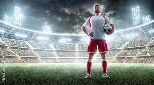 Night stadium panorama. Soccer player holds a soccer ball. Sport concept. Mockup © Ruslan Shevchenko