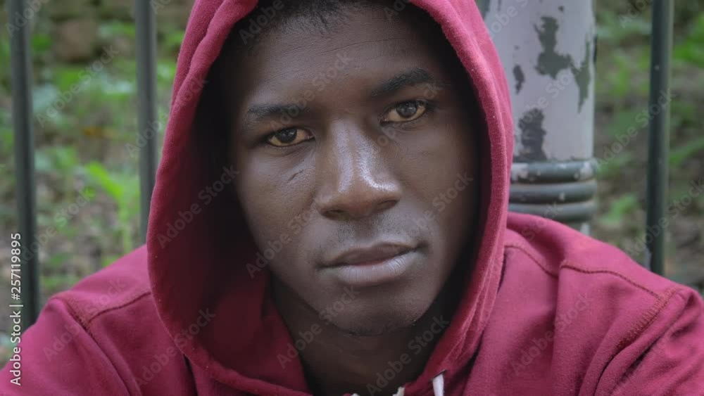 serious confident american african hooded man staring at camera-outdoor serious confident american african hooded man staring at camera-outdoor