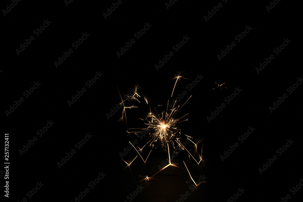 Fototapeta premium yellow sparks on a black background