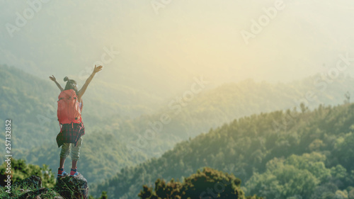 Happy women on mountain summit enjoying aerial view hands raised over clouds Travel Lifestyle success concept adventure active vacations outdoor freedom emotions