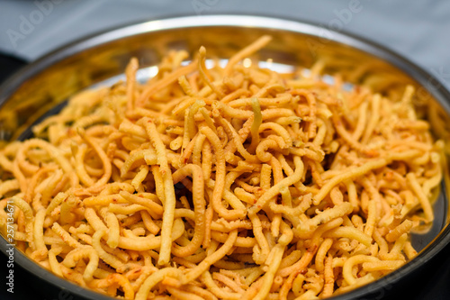 Srilankan spicy snack mixture in a silver plate.