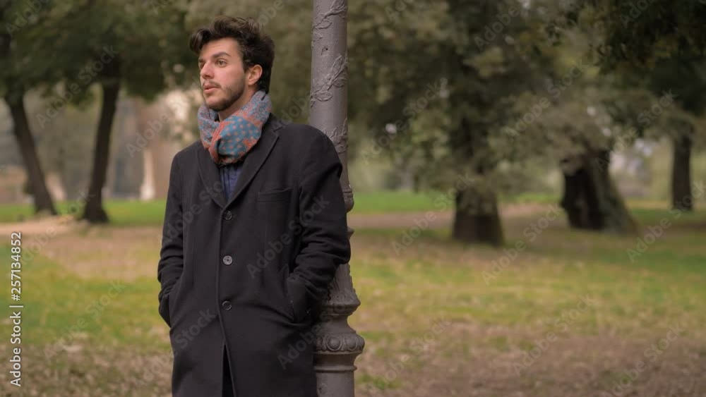 appointment, late.Attractive man alone in the park waiting for girlfriend appointment, late.Attractive man alone in the park waiting for girlfriend