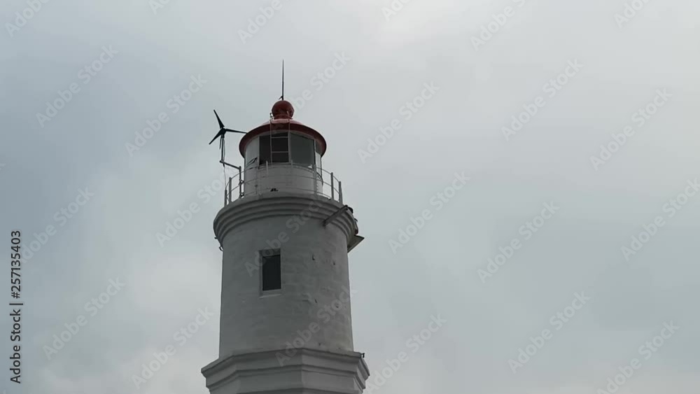 Landscape with a white lighthouse against a cloudy sky. Vladivostok, Primorsky Krai. Landscape with a white lighthouse against a cloudy sky. Vladivostok, Primorsky Krai.