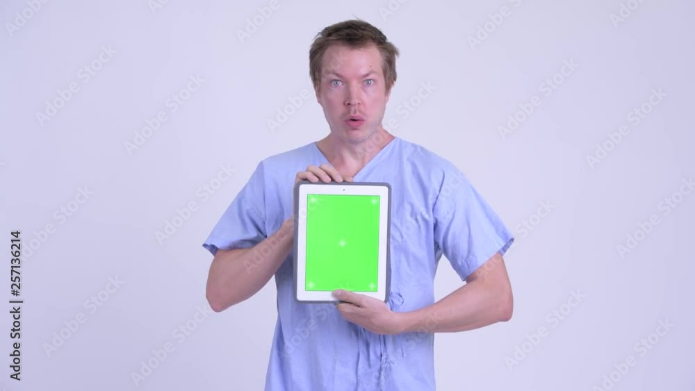 Portrait of young man patient showing digital tablet and looking shocked Portrait of young man patient showing digital tablet and looking shocked