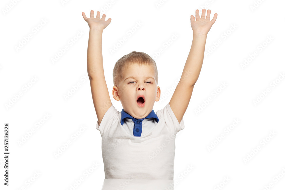Cute little boy yawns and stretches, isolated on white background Cute little boy yawns and stretches, isolated on white background