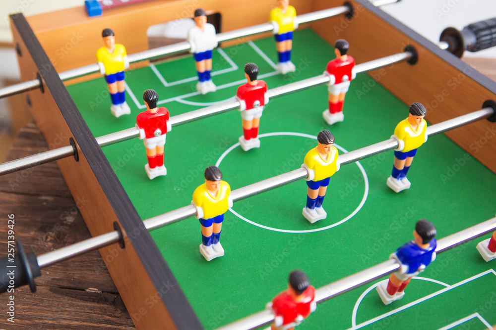 Table football game with yellow and red players and white goalkeeper. Table soccer game. Table football game with yellow and red players and white goalkeeper. Table soccer game.